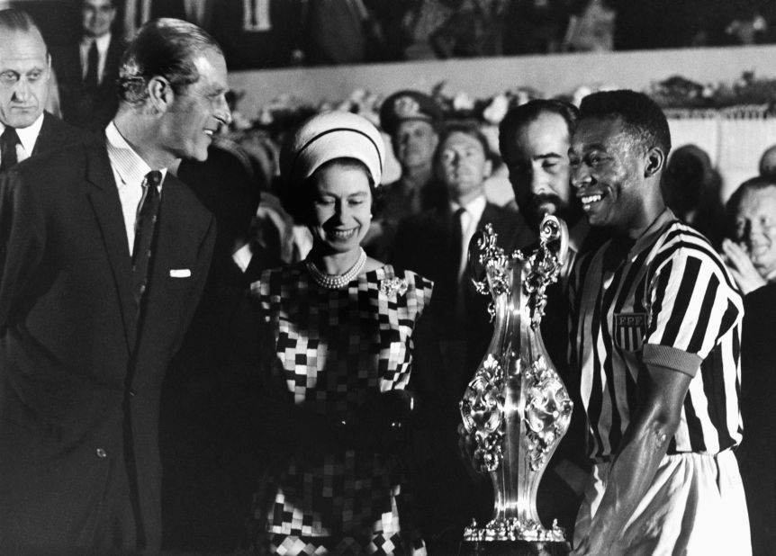 Britain's Queen Elizabeth II, accompanied by her husband, Prince Philip, award a trophy to Pelé after watching a match in Rio de Janeiro in 1968.