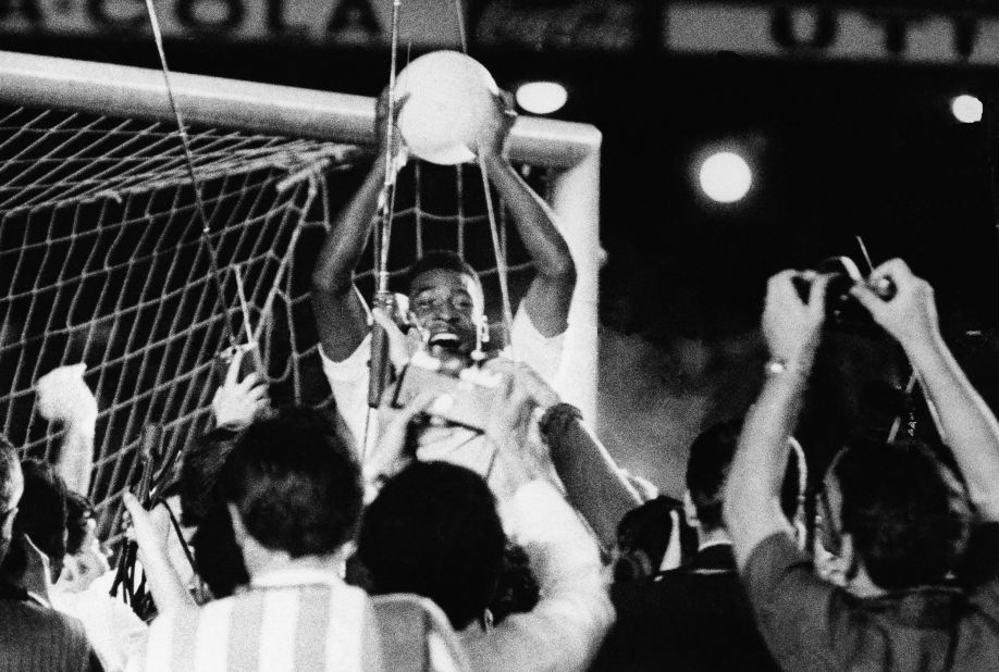 Pelé celebrates with fans after scoring his 1,000th career goal in 1969.