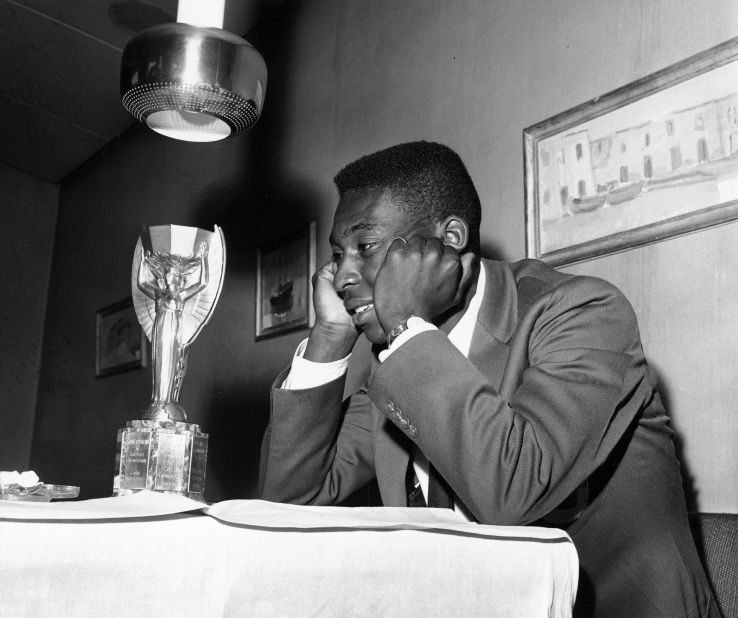 Pelé admires the Jules Rimet Trophy, the prize for winning the World Cup, circa 1958.