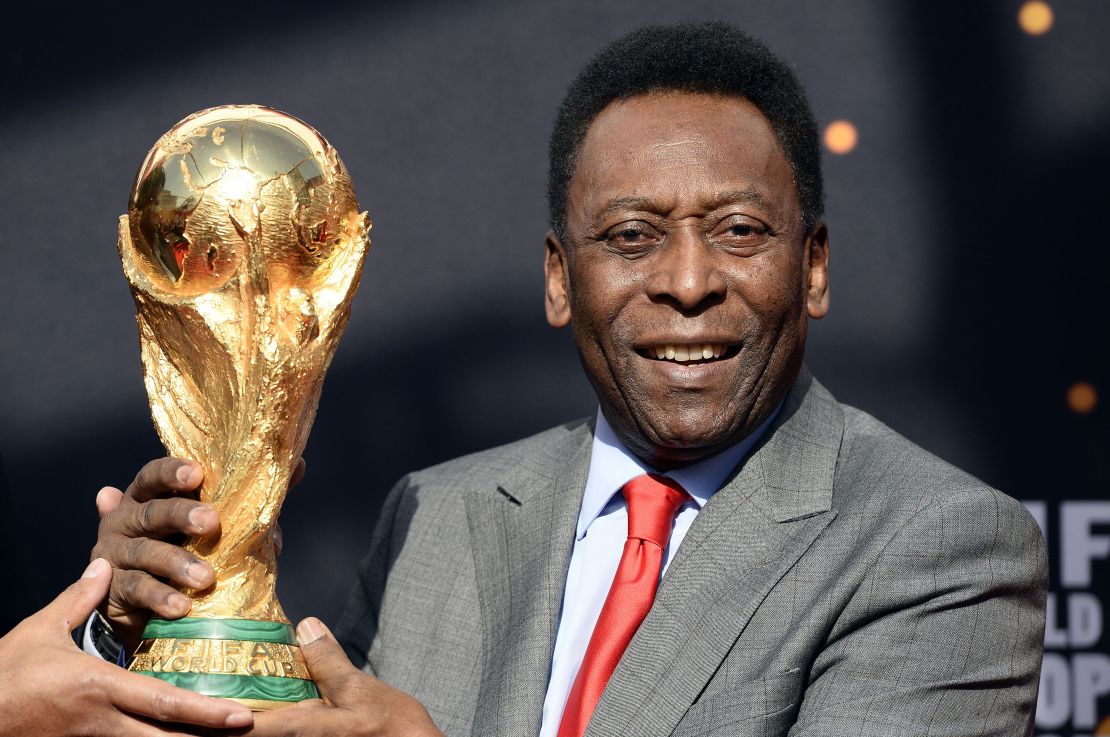 Pelé poses with the World Cup trophy on March 9, 2014, in Paris.