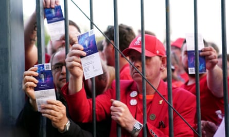 Liverpool fans stuck outside the ground showing their match tickets before the 2022 Champions League final in Paris