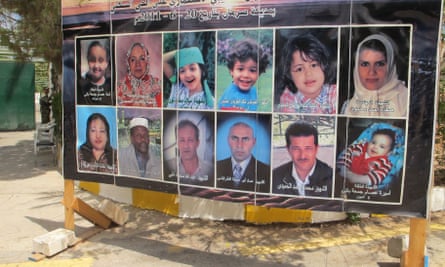 Pictures of people on a board erected on a street