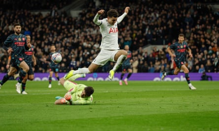 Manchester City’s goalkeeper Stefan Ortega saves at the feet of Tottenham’s Brennan Johnson