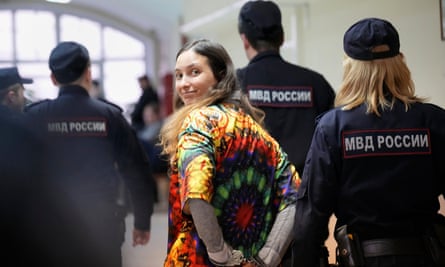 Sasha Skochilenko, a 33-year-old artist and musician, walks escorted by officers to the court room for a hearing in the Vasileostrovsky district court in St Petersburg, Russia, on 19 October 2023.