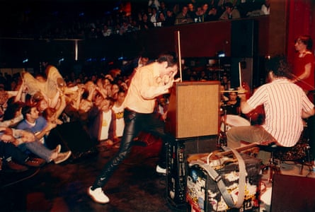 Jon, of the eponymous Blues Explosion, leaning into their signature theremin, with the band performing in front of a crowd