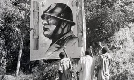Residents of Tigre province in 1935 looking at a huge poster of the Italian fascist leader Mussolini.