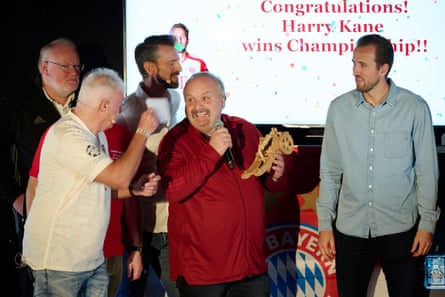Harry Kane is presented with the trophy for his victory in a Bavarian mini-Olympics.