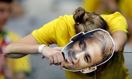 A Brazilian supporter holding a Neymar face mask reacts after Germany 7-1 win in 2014.