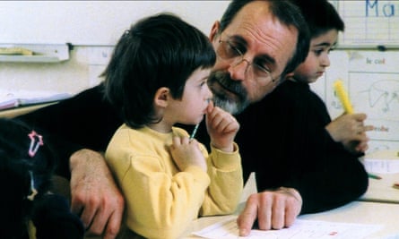 Teacher Georges Lopez with young Letitia in Être et Avoir.