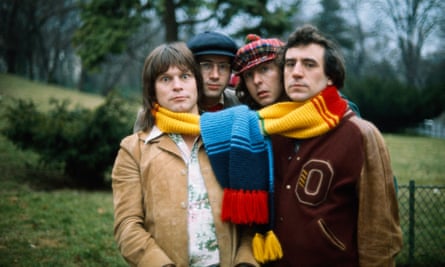 Terry Gilliam, Neil Innes, Eric Idle and Terry Jones with a large scarf wrapped round the four of them
