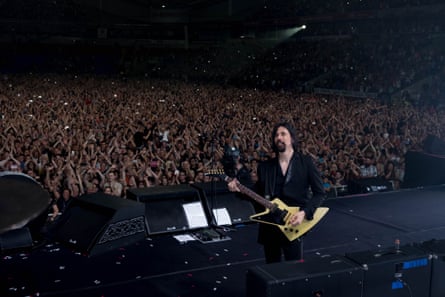 Ted Sablay with the Killers in concert at Macron Stadium, Bolton, in July 2018.