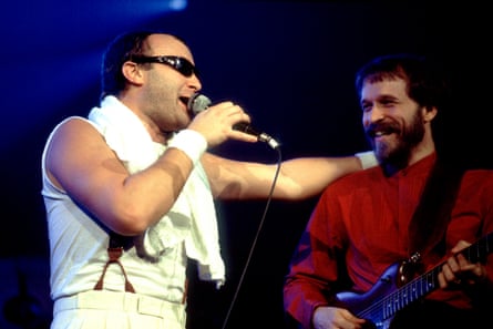 Daryl Stuermer with Phil Collins in 1983 as Genesis perform on stage at the Rosemont Horizon, Illinois.