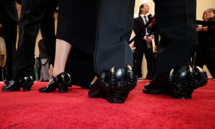The crew of Godzilla Minus One walk the red carpet in Godzilla-themed shoes.