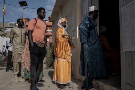 People line up to vote in the presidential election in Dakar, Senegal