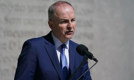 Micheál Martin in a blue suit speaking into a microphone