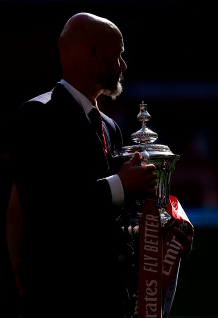 Erik ten Hag holds the FA Cup.