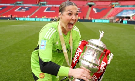 Mary Earps celebrates with the trophy after Manchester United thrashed Tottenham at Wembley