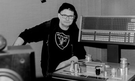 black and white photo of a man in a recording studio