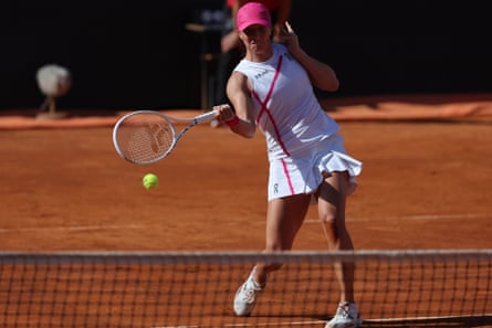 Iga Swiatek powers a return against Coco Gauff during their Italian Open semi-final in 2024