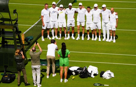 Novak Djokovic and Jannik Sinner poses for a photo with their teams after practising on Wimbledon’s Centre Court on 27 June 2024