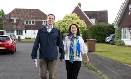 Jeremy Hunt hand-in-hand with his wife, Lucia, on a suburban road