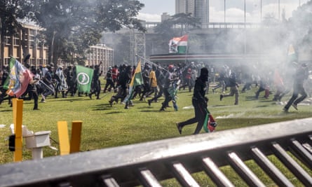 Protesters running inside the Kenyan parliament compound.