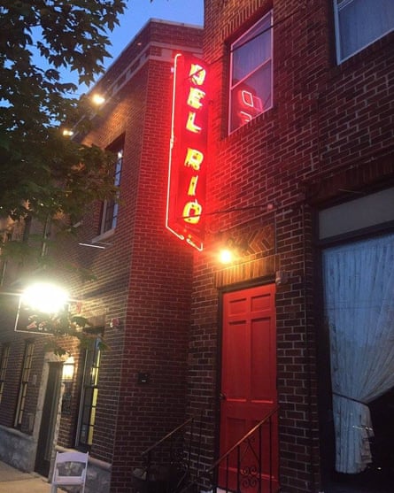 The exterior of the Del Rio restaurant, with a neon light shining the name