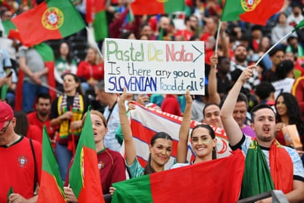 Fans of Portugal pose for a photo with a sign