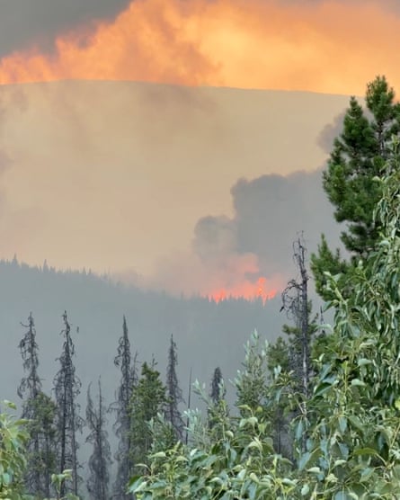 A fire is seen on the horizon with large amounts of smoke behind