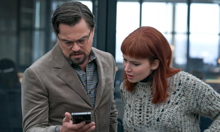 film still of man and woman looking at a phone