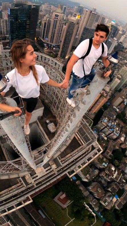 Beerkus and Nikolau hold hands on top of a skyscraper in Shenzhen, China