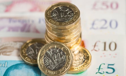 UK five pound, ten pound, twenty pound and fifty pound notes with one pound coin