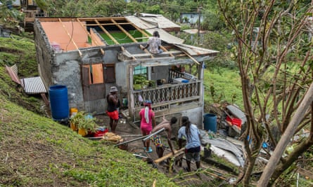 A family begin to repair their home damaged in the passing of Hurricane Beryl