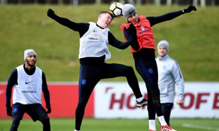 Alfie Mawson (left) challenges Dele Alli during an England training session in March 2018