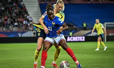 Sandy Baltimore shields the ball, playing for France against Sweden