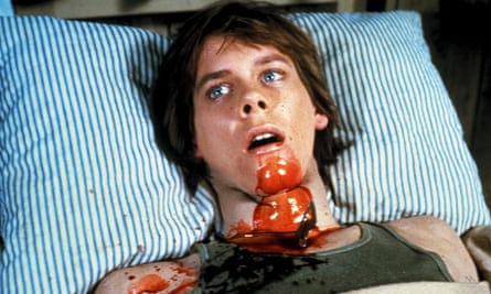 A young Kevin Bacon, ‘blood’ on his chin and neck, in Friday the 13th.