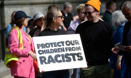 About 15,000 join Belfast anti-racism rally as trouble flares in Derry