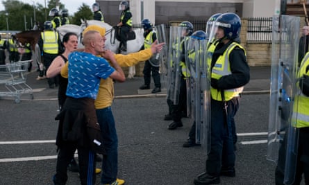 People confront police officers.