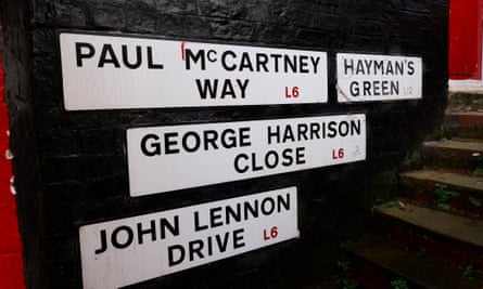 Signs on an outside wall that say ‘Paul McCartney Way’, ‘Hayman’s Green’, ‘George Harrison Close’ and ‘John Lennon Drive’