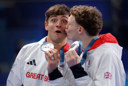 Tom Daley is kissed by his British diving partner Noah Williams after winning silver medals in the diving 10m synchronised event