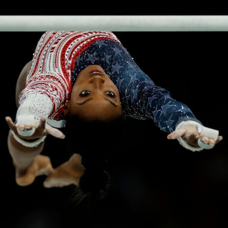 Simone Biles performs on the uneven bars during the final of the women’s gymnastics all-around team event