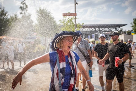 Tennis fans try to stay cool at Roland Garros during the Olympic Games tennis tournament where the temperature rose to 37 centigrade.