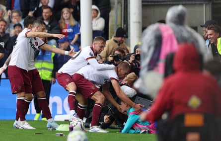 Tomas Soucek and Jarrod Bowen of West Ham United help s a ball boy who is crushed by a damaged LED advertising board