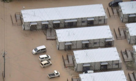 Houses and cars surrounded by flood water