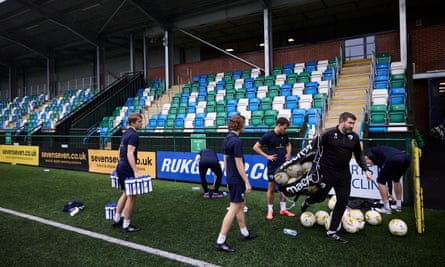 Chris Seargeant, the assistant manager, collecting all the balls together after the training session