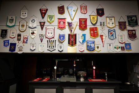 European team’s pennants, souvenirs from TNS’s previous European exploits, hanging above the bar at Park Hall