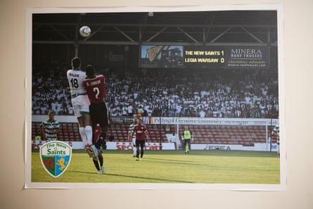 A club photograph, mounted on the corridor wall at Park Hall, showing TNS in Champions League qualifying action against Legia Warsaw in 2013