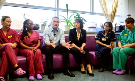 Rachel Reeves and Wes Streeting sitting with hospital workers