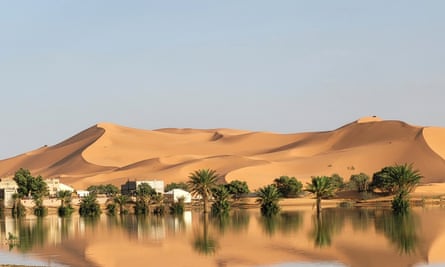 An oasis is reflected in a lake caused by heavy rainfall in the desert town of Merzouga, near Rachidia, south-east Morocco.