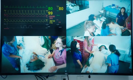 A big screen showing images of doctors with patients